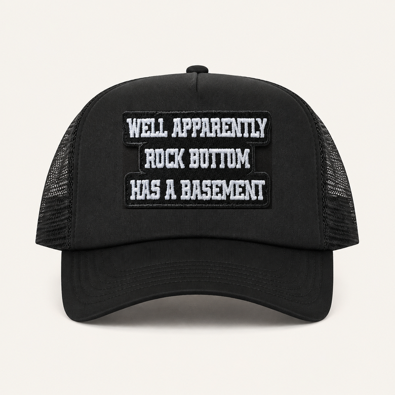 Black ROCK BOTTOM HAS A BASEMENT trucker hat front view